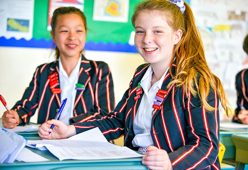 Pupils studying inside a in classroom at Castle Court School, Dorset