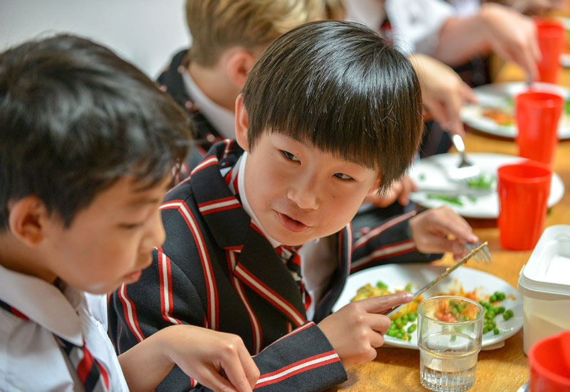 Pupils catching up over lunch at Castle Court School, Corfe Mullen, Wimborne, Dorset BH21 3RF