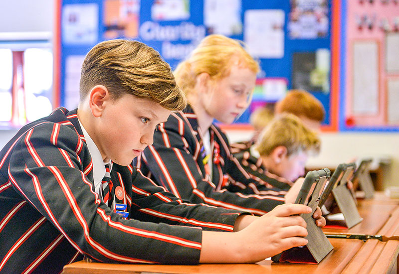 Year 5 pupils in class with ipad, ipads, probooks, Castle Court School, Corfe Mullen, Wimborne, Dorset