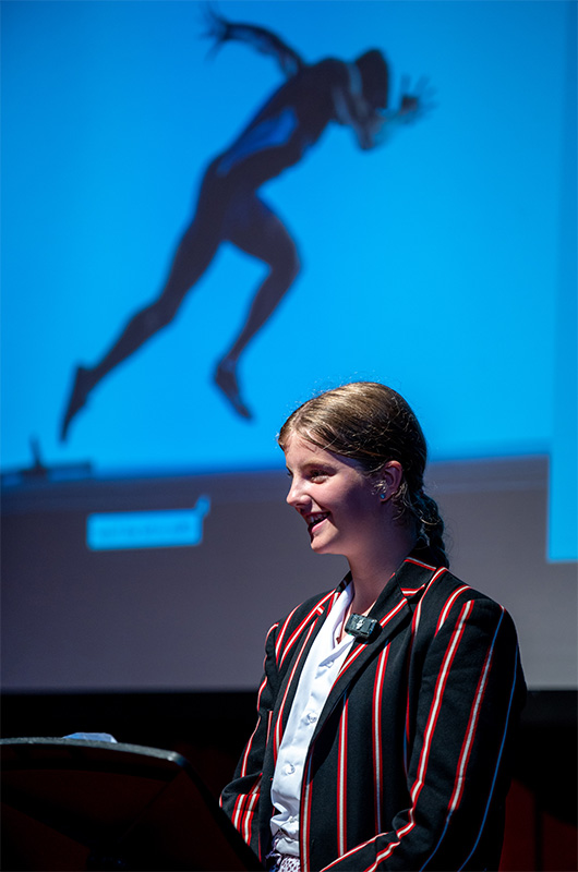 photo of student presenting on stage