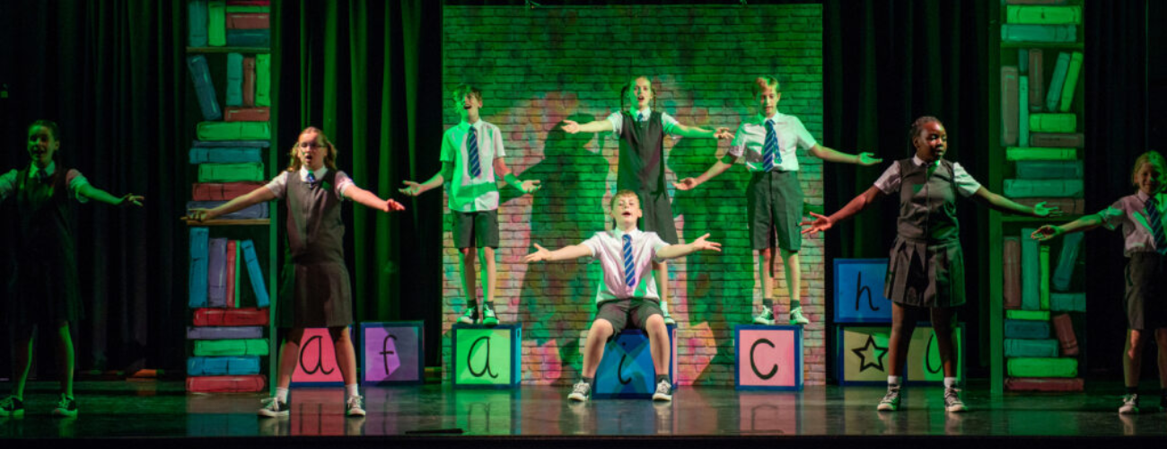 a group of students performing on stage