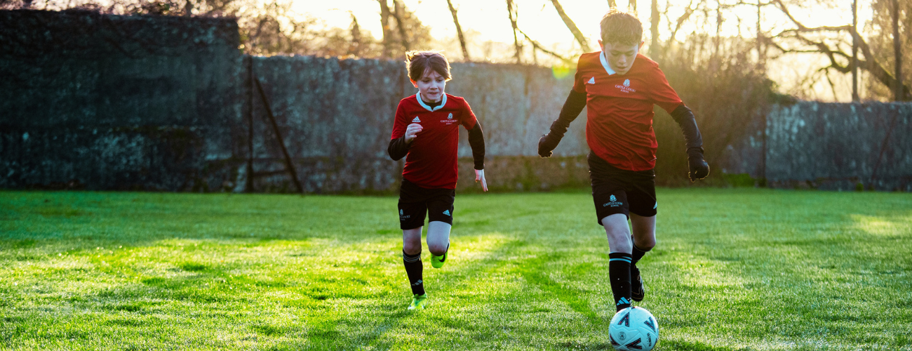 two kids playing football