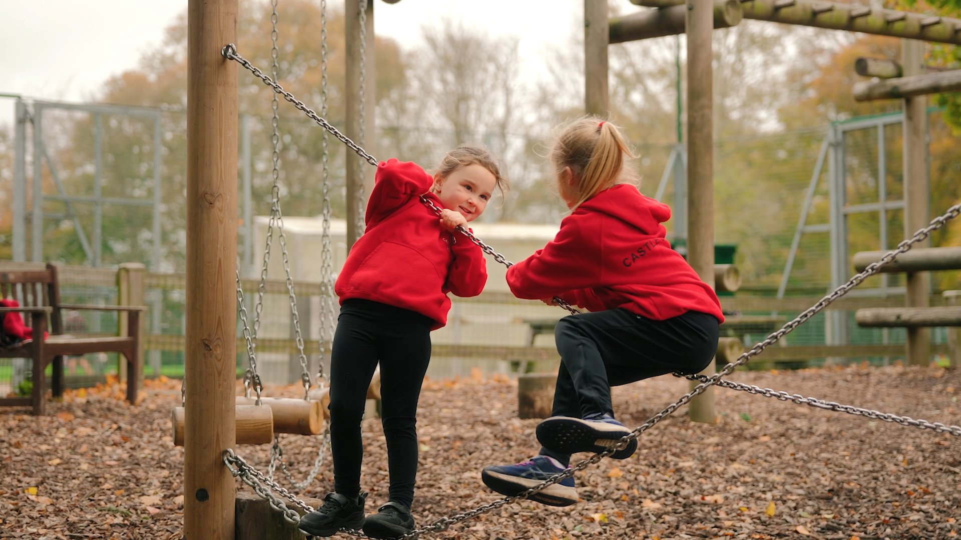 photo of two girls playing in the school park