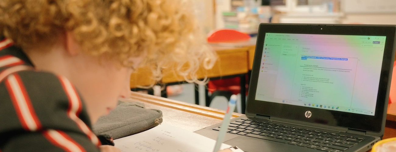 photo of student completing school work on laptop